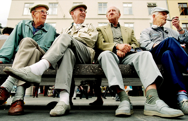 Four older men sitting on a bench