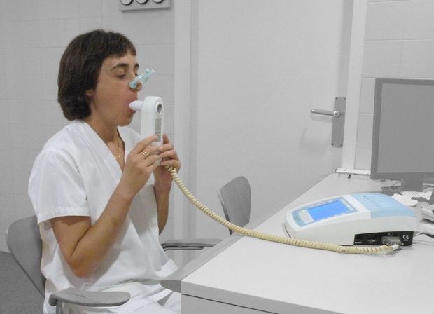 a woman taking a spirometry machine
