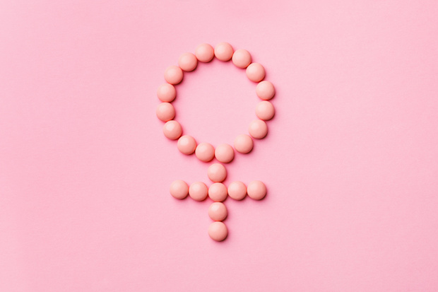 pink pills in the shape of the female symbol