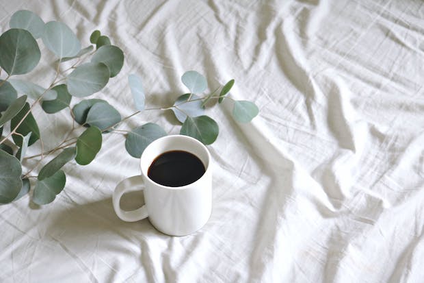 A cup of coffee on a white sheet