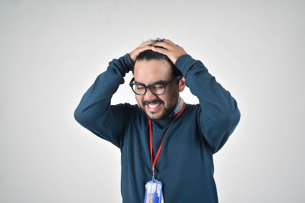 a man holding his head in stress