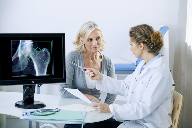 a doctor showing an older woman an x-ray